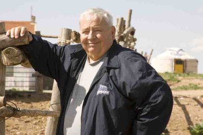 Expatriate holding up a fence