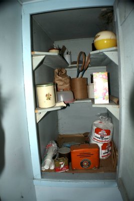 Kitchen supplies in the front porch pantry