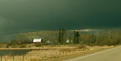 Pastoral farm scene mixed with a storm front.