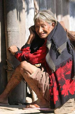 Khiamniungan Naga lady in Nokyan with tattoos on her legs.