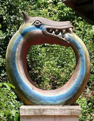 In the Sacred Forest of Ouidah, Vodun Dan, the snake rainbow god. The serpent eating its own tail symbolizes the Circle of Life.