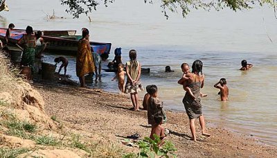 Kachork people taking a bath in Tonl San River, Cambodia.