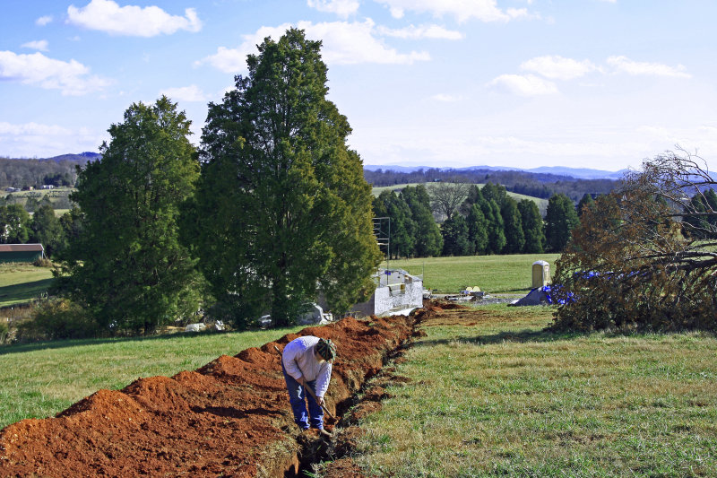 Putting in the last piece of the direct-burial electric line