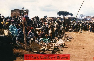 Views from within the Zambian Company of the United Nations Assistance Mission for Rwanda (UNAMIR) at about 14:30 on Tuesday, 18 April 1995. Note the relative calm, despite great pressure around the camp, which, in some places has broken down razor-wire fencing.