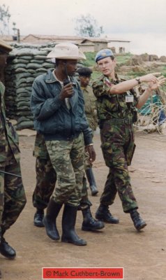 Major Mark Cuthbert-Brown walks through Kibeho with Captain Shema of the RPA, Indicating the direction in which the mass of IDPs fled on 22 April. (Photograph taken by John Cleland using the camera of Mark Cuthbert-Brown.)