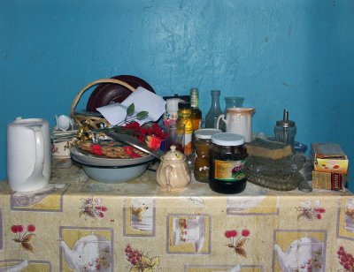 still life with old kitchen table and plastic roses