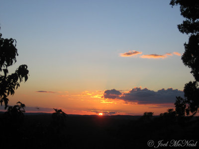 View of sunset over jungle from atop Temple IV