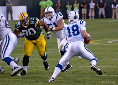 Peyton Manning (18) chased by B.J. Raji (90), 