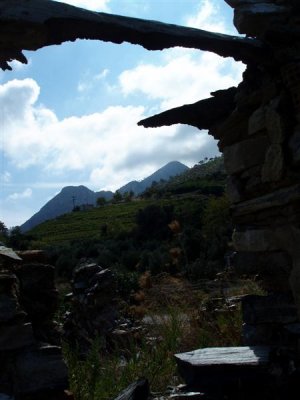 Mount Ambelos through crumbling window frame