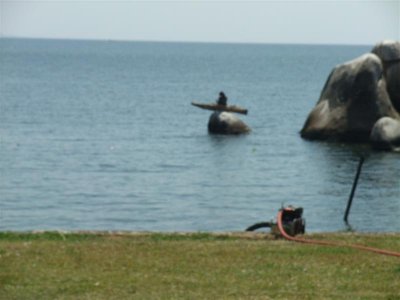 Bizarre - fisherman sitting in canoe on top of a rock, know its out of focus but ,,,,,