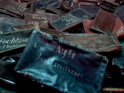 Auschwitz - suitcases stacked high - each bearing name and address in case they were lost en route