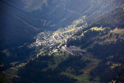 Town of Grimentz across the valley, lit through the clouds.