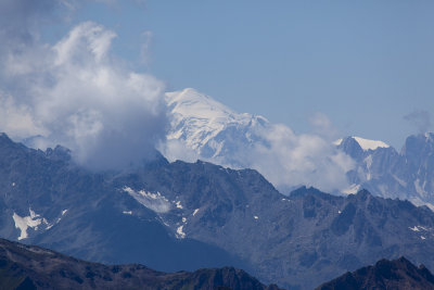 The Mont Blanc peaking through the clouds in the distance.