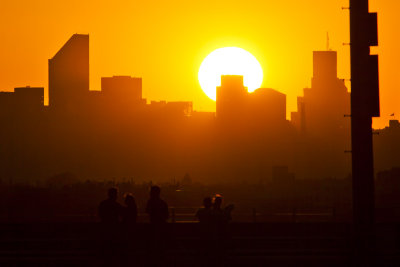 Sunset over Manhattan, onlookers from Ashe in the foreground.