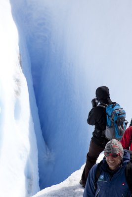 Anne staring into a big crevasse on the Perito Moreno Glacier.