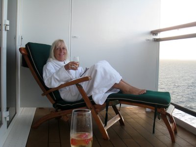 Rene enjoying a glass of champagne on our balcony on the Queen Mary 2 December 20 2008