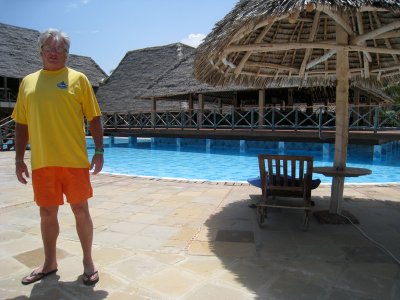 Dave, resplendent in yellow and orange :-) standing in front of the pool bar
