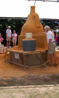 Ed More of Sandy Feat creating  a sand sculpture in Moore Square with several other artists