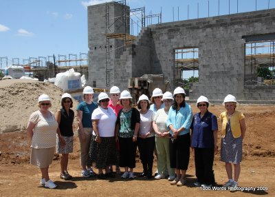 The faculty gathers on the last day of school to check out the progress on the new building.