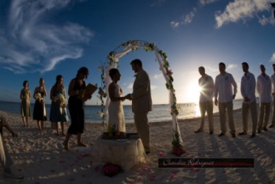 White metal arch with fabric and florals. Photo by Claudia, Claudia Rodriguez Photography