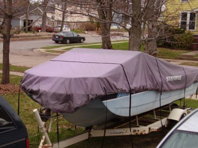 The cover... over a tarp... and covered by another inexpensive tarp to keep the canvas from sun damage