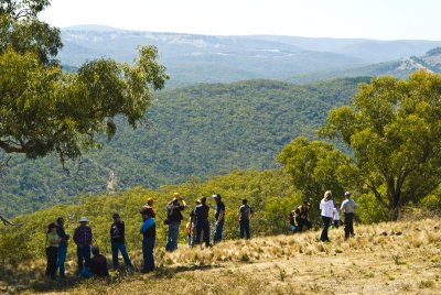 VISITORS ENJOY THE VIEW OVER ROLLING HILLS BESIDE THE TABLELANDS WAY