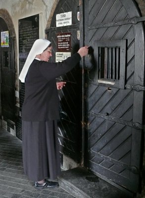 Nun Unlocking Church Door