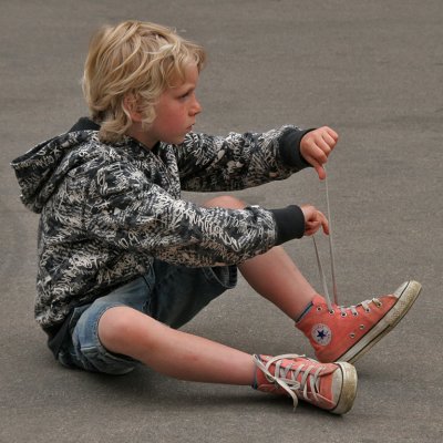 Boy Tying Shoe Laces