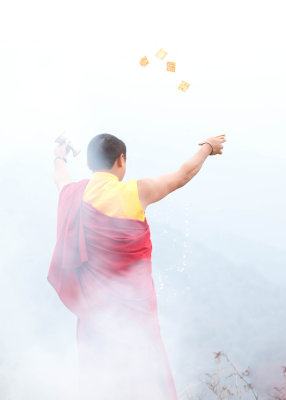 Bhutan - Throwing an offering off a mountain top