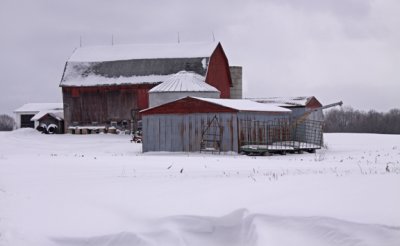red grey barn in the snow