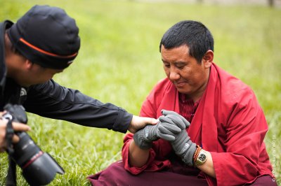 Jason asked a monk to wear his gloves for a photograph