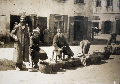 Jewish tradesmen with baskets full of vegetables and fruits on the market