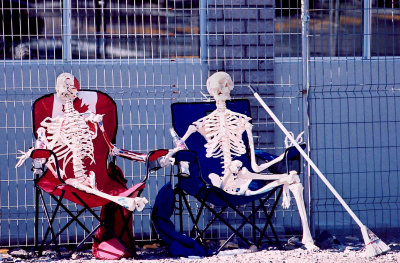 Skeletons in chairs