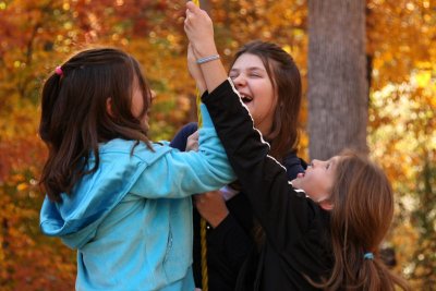 Three girls on a swing