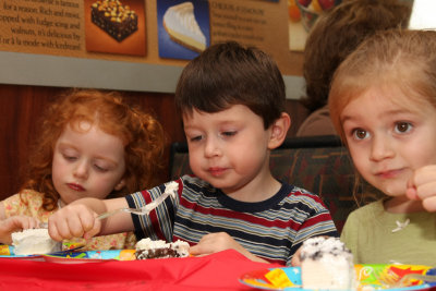 Enjoying cake with friends from pre-school