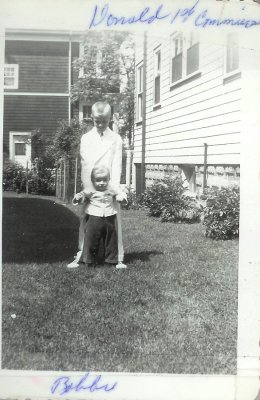Donald Mackie 1st communion 1949 holding Robert Mackie.jpg