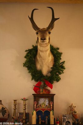 Deer with wreath on mantle