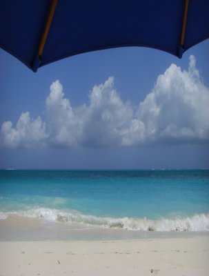 Umbrella and quiet rolling surf in front of our condo