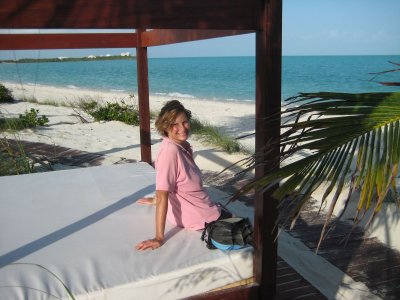 Galina sits on beach bed-the shore club sales site