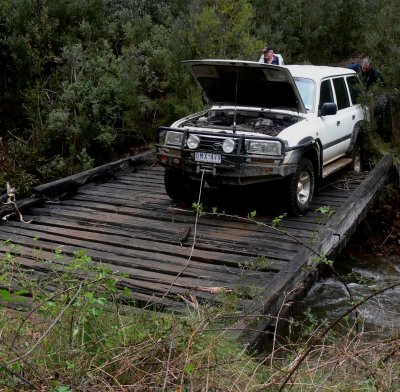 Macca needing a winch after section of bridge collapsed whilst crossing Paddys Joy Creek 