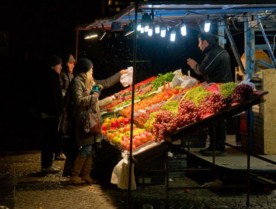 Buying fruit at the market on a snowy evening in early March