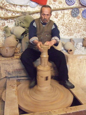 The potter's wheel in this part of Turkey is traditionally spun with the foot.