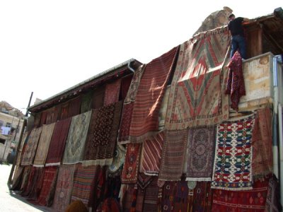 Goreme: Carpet shop owner in Goreme (upper right) preparing for the summer crowds.