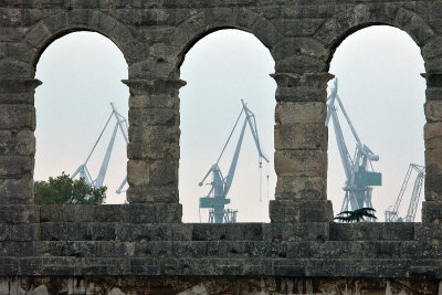 Pula - Amphitheatre and dockyard cranes