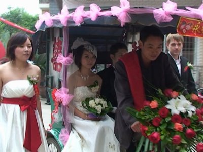 best man and bridemaid walk alongside SanLunChe tradition