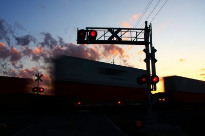 Intermodal stacks fly through the crossing at St James during sunset
