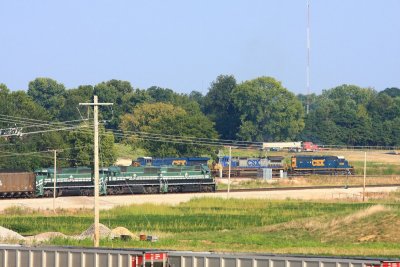SB grain train passes by an EVWR powered coal train at Alliance