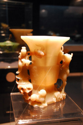Gu, a type of food vessel, with design of a figure and a unicorn, yellow jade, Qing Dyansty