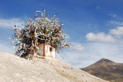 Shrine covered with prayer flags on the ridge bisecting old town Gyantse