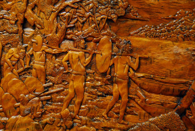 Panel 2: Men carrying the completed stone money down to the canoes for the return voyage to Yap